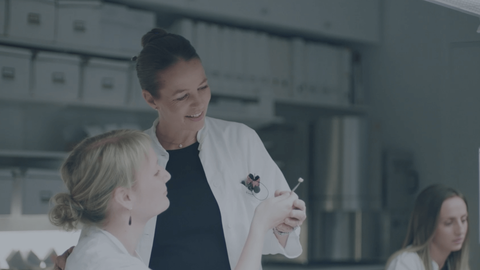 two people are discussing an instrument